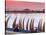 Waterfront Scene at Huanchaco in Peru, Locals Relax Next to Totora Boats Stacked Along the Beach-Andrew Watson-Stretched Canvas