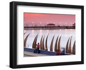 Waterfront Scene at Huanchaco in Peru, Locals Relax Next to Totora Boats Stacked Along the Beach-Andrew Watson-Framed Photographic Print