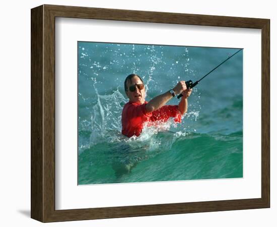 Waves Splash President-Elect George Bush as He Casts a Line While Surf-Fishing-null-Framed Photographic Print