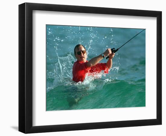 Waves Splash President-Elect George Bush as He Casts a Line While Surf-Fishing-null-Framed Photographic Print