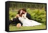 Wedding, Beautiful Young Bride Lying Together with Groom in Love on Green Grass Kissing-khorzhevska-Framed Stretched Canvas