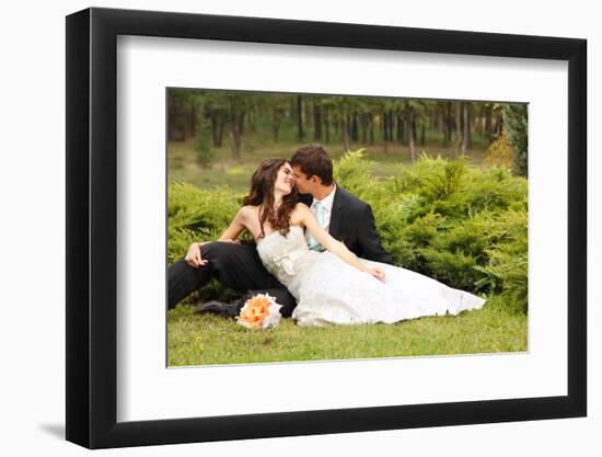 Wedding, Beautiful Young Bride Lying Together with Groom in Love on Green Grass Kissing-khorzhevska-Framed Photographic Print