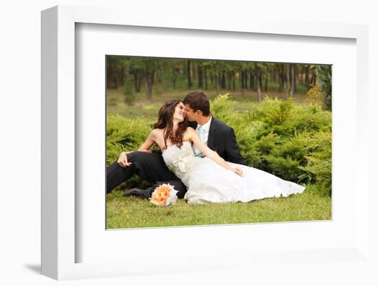 Wedding, Beautiful Young Bride Lying Together with Groom in Love on Green Grass Kissing-khorzhevska-Framed Photographic Print