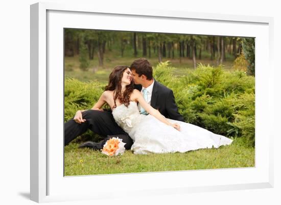 Wedding, Beautiful Young Bride Lying Together with Groom in Love on Green Grass Kissing-khorzhevska-Framed Photographic Print