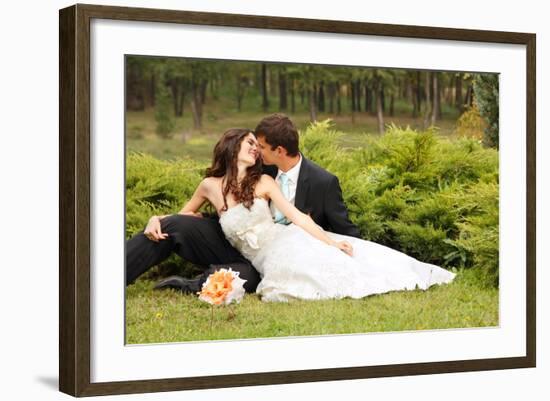 Wedding, Beautiful Young Bride Lying Together with Groom in Love on Green Grass Kissing-khorzhevska-Framed Photographic Print