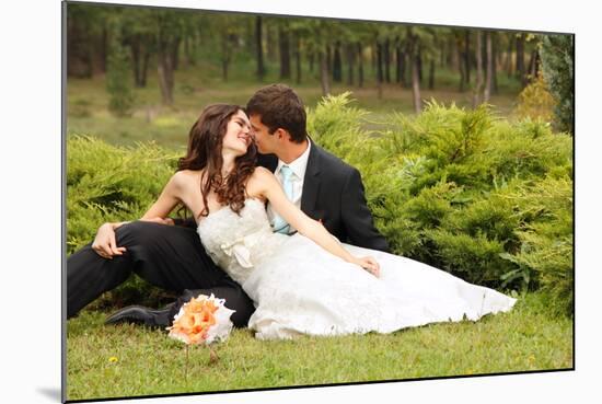 Wedding, Beautiful Young Bride Lying Together with Groom in Love on Green Grass Kissing-khorzhevska-Mounted Photographic Print