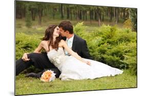 Wedding, Beautiful Young Bride Lying Together with Groom in Love on Green Grass Kissing-khorzhevska-Mounted Photographic Print