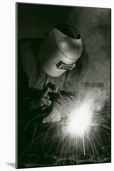 Welder in Mask-null-Mounted Art Print