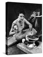 Well-Dressed Woman Cooking a Large Steak on the Aluminum Disposable Barbecue Grill-Peter Stackpole-Stretched Canvas