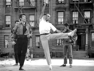 https://imgc.allpostersimages.com/img/posters/west-side-story-george-chakiris-gets-some-dancing-moves-from-co-director-jerome-robbins-1961_u-L-Q1BUCCE0.jpg?artPerspective=n