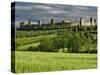 Wheat field and distant Monteriggioni, Siena, Tuscany, Italy-Adam Jones-Stretched Canvas