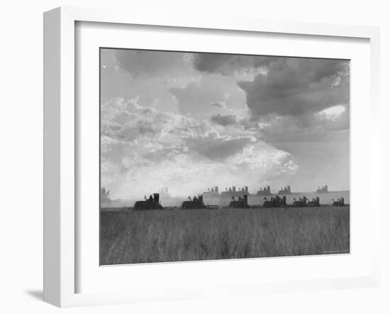 Wheat Harvest Time with Two Lines of Combines Lining Up in Field with Threatening Sky-Joe Scherschel-Framed Photographic Print