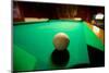 White pool ball lit by electric lights in a restaurant and bar in Shoshone, CA near Death Valley...-null-Mounted Photographic Print