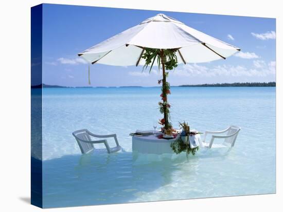 White Table, Chairs and Parasol in the Ocean, Bora Bora (Borabora), Society Islands-Mark Mawson-Stretched Canvas