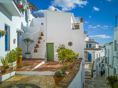 https://imgc.allpostersimages.com/img/posters/white-washed-houses-lining-a-winding-street-frigiliana-white-village-malaga-province-andaluci_u-L-Q1HPHBP0.jpg?artPerspective=n