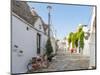 Whitewashed trulli houses along street in the old town, Alberobello, Puglia-Karen Deakin-Mounted Photographic Print