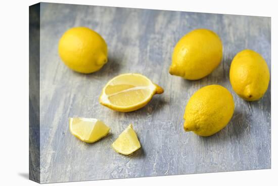 Whole and Sliced Lemons on Grey Subsoil-Jana Ihle-Stretched Canvas