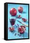 Whole and Sliced Pomegranate and Glass of Pomegranate Juice on Turquoise Wooden Table-Jana Ihle-Framed Stretched Canvas