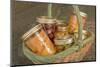 Wicker basket of home canned foods (peaches, olives and cherries) in a kitchen.-Janet Horton-Mounted Photographic Print