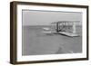 Wilbur Wright in damaged plane after unsuccesful flight Photograph - Kitty Hawk, NC-Lantern Press-Framed Art Print