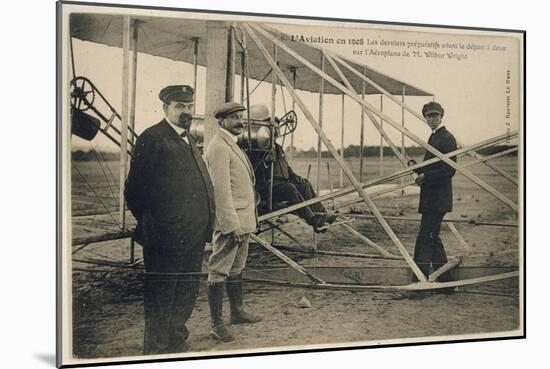 Wilbur Wright Makes a Last Minute Check Before Taking to the Air with a Passenger-null-Mounted Art Print