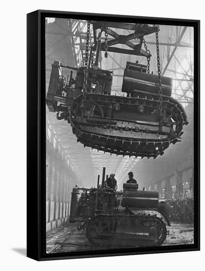 Winching a Tank with an Overhead Crane at a Factory in St. Petersburg-null-Framed Stretched Canvas