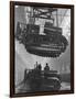 Winching a Tank with an Overhead Crane at a Factory in St. Petersburg-null-Framed Art Print