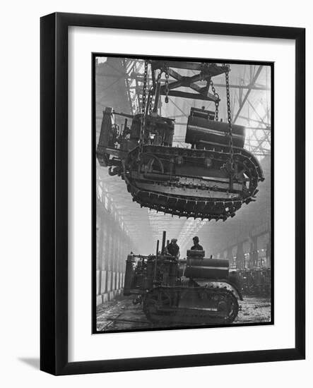 Winching a Tank with an Overhead Crane at a Factory in St. Petersburg-null-Framed Art Print