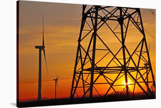 Windmills, pylon and power lines in morning light, Germany, Europe-Hans-Peter Merten-Stretched Canvas