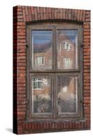 Window in a rowhouse in Wislica, Poland with reflections from the home across the street.-Mallorie Ostrowitz-Stretched Canvas