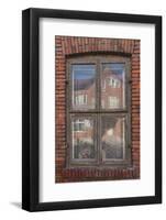 Window in a rowhouse in Wislica, Poland with reflections from the home across the street.-Mallorie Ostrowitz-Framed Photographic Print