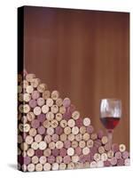 Wine Corks, Piled Up, and a Glass of Red Wine-Henrik Freek-Stretched Canvas
