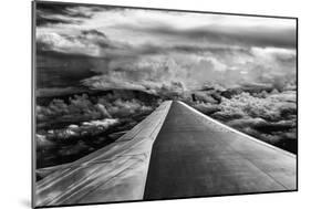 Wing of Airplane Flying in Mid-Air under and Between Clouds-Liyun Yu-Mounted Photographic Print