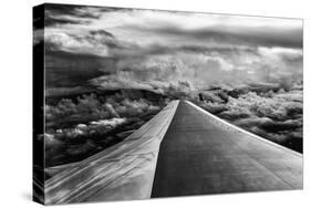 Wing of Airplane Flying in Mid-Air under and Between Clouds-Liyun Yu-Stretched Canvas