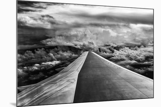 Wing of Airplane Flying in Mid-Air under and Between Clouds-Liyun Yu-Mounted Photographic Print