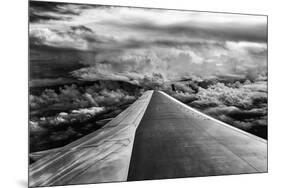 Wing of Airplane Flying in Mid-Air under and Between Clouds-Liyun Yu-Mounted Photographic Print