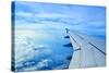 Wing of an Airplane Flying Above the Clouds-ghoststone-Stretched Canvas