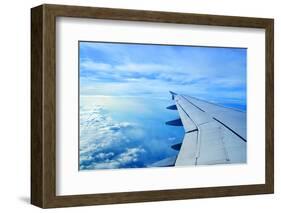 Wing of an Airplane Flying Above the Clouds-ghoststone-Framed Photographic Print