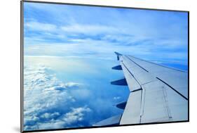 Wing of an Airplane Flying Above the Clouds-ghoststone-Mounted Photographic Print