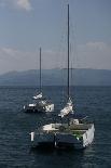 Several Sailboats Floating in the Ocean with Mountains and Clouds in the Background-Wirestock-Photographic Print