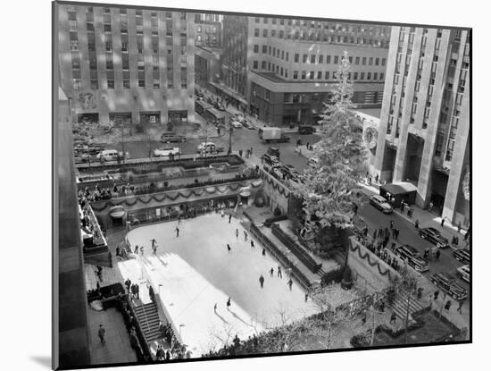 With the Famed Rockefeller Center Christmas Tree Rising Above Them, Skaters Glide on the Ice-null-Mounted Premium Photographic Print