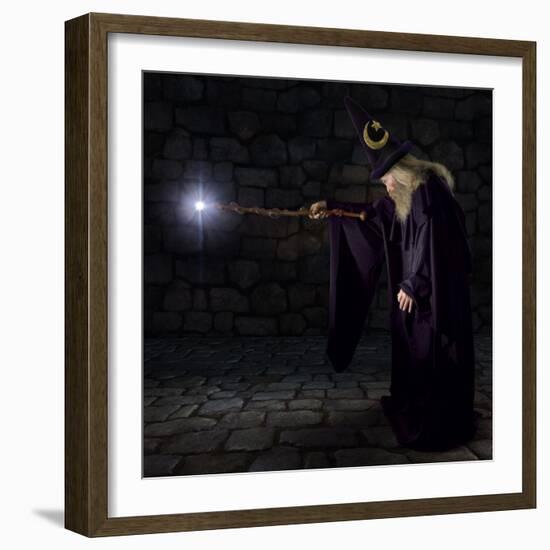 Wizard in a Purple Robe and Wizard Hat Casting a Spell with His Wand-James Steidl-Framed Photographic Print