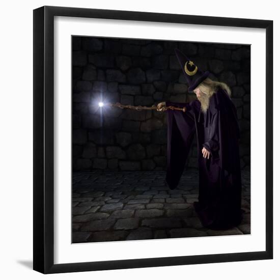 Wizard in a Purple Robe and Wizard Hat Casting a Spell with His Wand-James Steidl-Framed Photographic Print