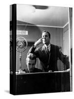 Wolfe, NBC Radio Director, Makes Timing Gestures Through the Glass Window of the Control Room-Alfred Eisenstaedt-Stretched Canvas