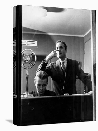 Wolfe, NBC Radio Director, Makes Timing Gestures Through the Glass Window of the Control Room-Alfred Eisenstaedt-Stretched Canvas