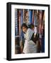 Woman and Baby, Cloth Shopkeeper in Temple Square, Bodhnath, Kathmandu, Nepal-Anthony Waltham-Framed Photographic Print