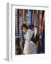 Woman and Baby, Cloth Shopkeeper in Temple Square, Bodhnath, Kathmandu, Nepal-Anthony Waltham-Framed Photographic Print