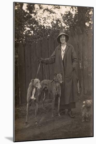 Woman and Dogs in Garden-null-Mounted Photographic Print