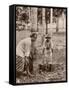 Woman and Young Boy Tap Rubber Trees in Malaya and Collect the Sap in Buckets-null-Framed Stretched Canvas