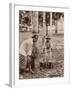 Woman and Young Boy Tap Rubber Trees in Malaya and Collect the Sap in Buckets-null-Framed Photographic Print